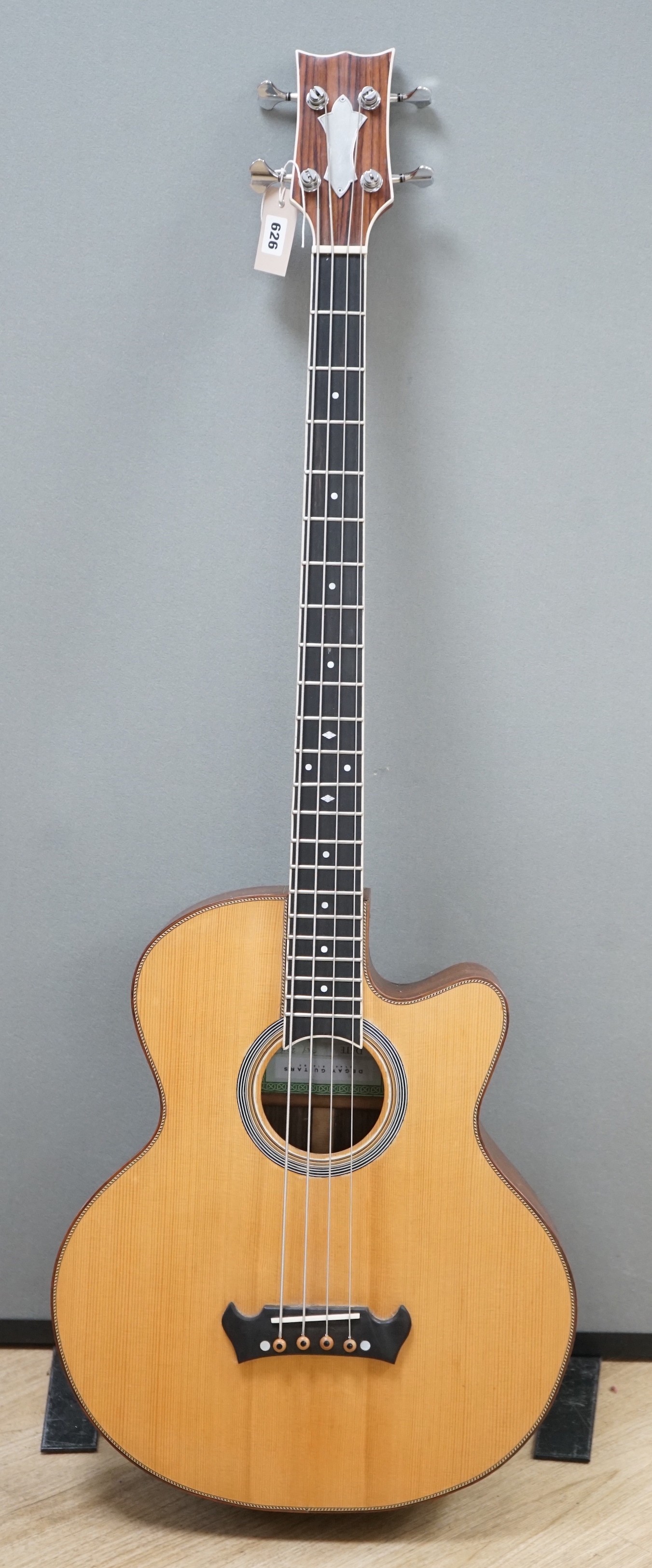 An Acoustic bass guitar, made by John Degay of Degay Guitars